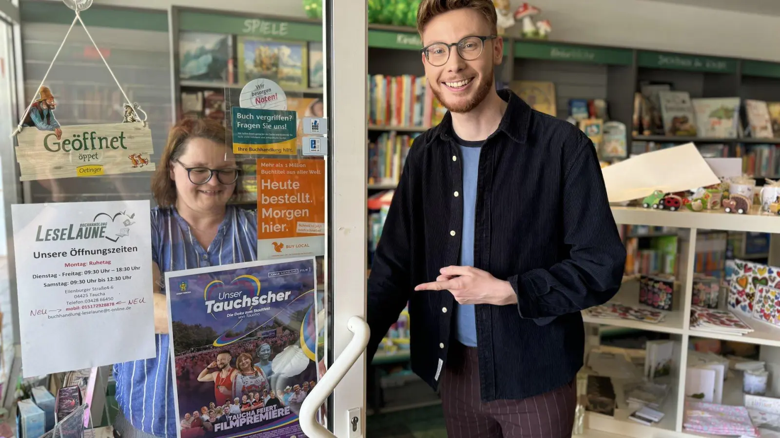 Conny Gutjahr von der LeseLaune hängt das Plakat zur Premiere des Filmes von Jonas Juckeland auf. (Foto: Daniel Große)